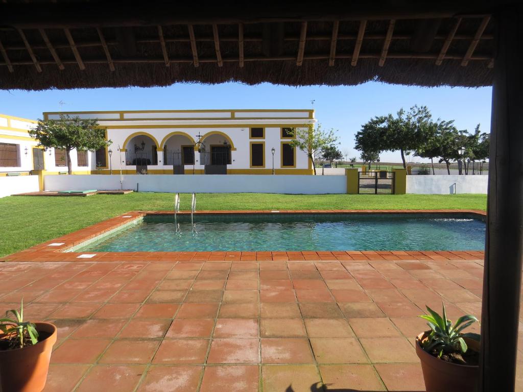 a swimming pool in front of a building at Sol de Balbaina in El Puerto de Santa María