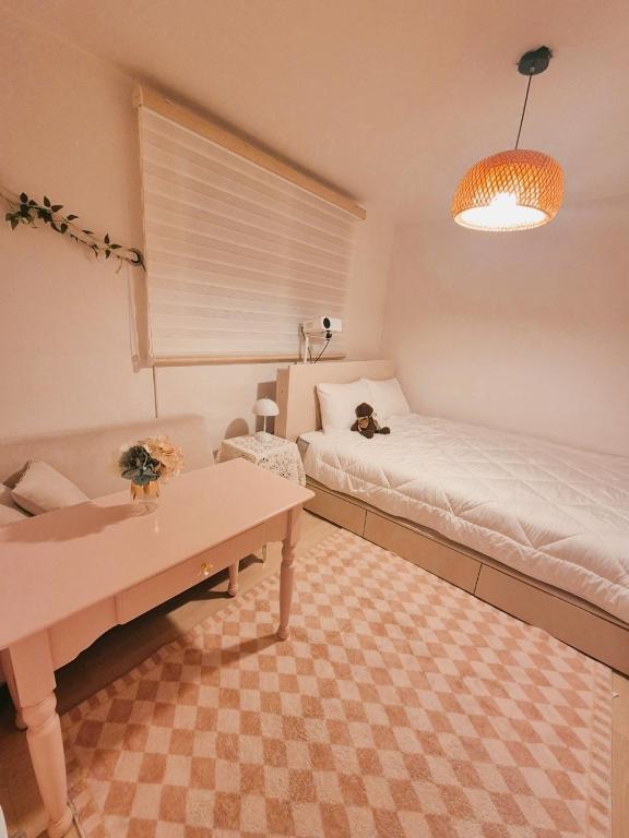 a room with two beds and a table in it at Daon 101 in Seoul