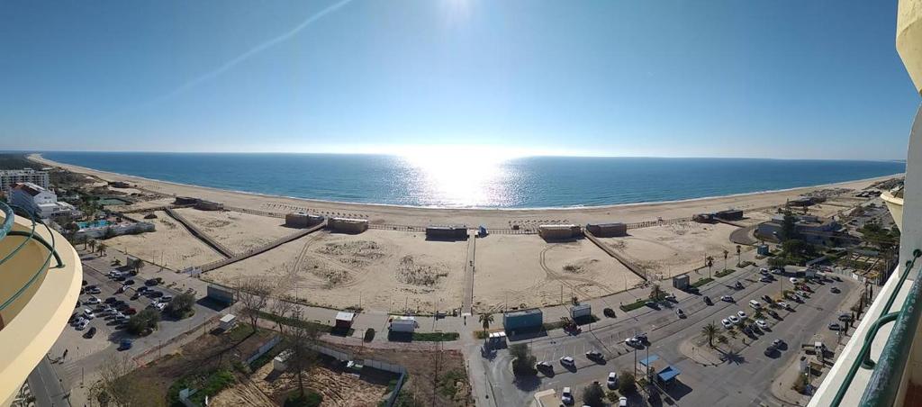 an overhead view of a beach and the ocean at Monte Gordo Beach Sky Flat in Monte Gordo