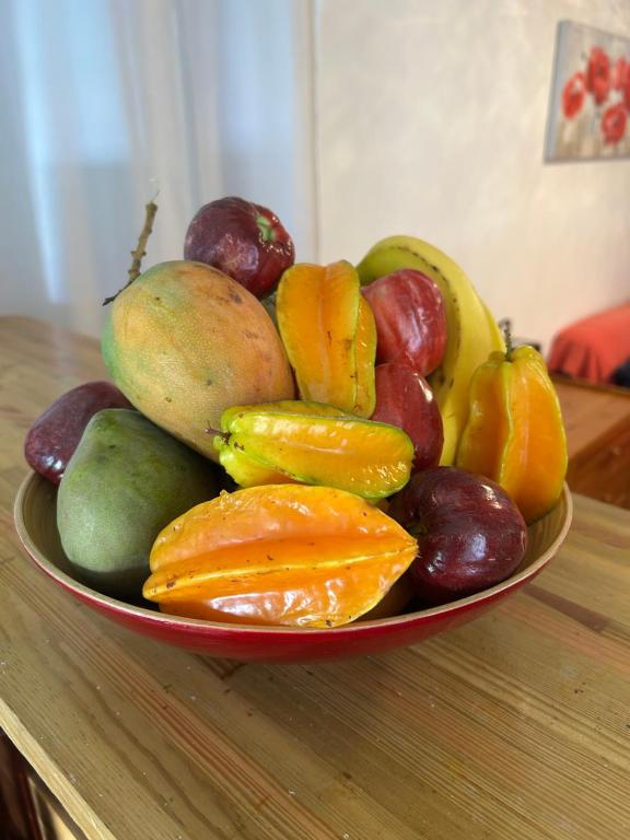 a bowl of fruits and vegetables on a table at Maison Petit Paradis in Basse-Terre