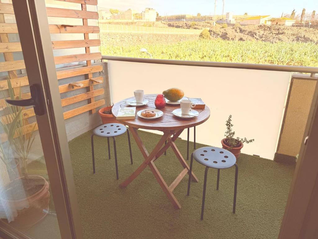 a small table with a plate of food on a balcony at Cali in Alcalá