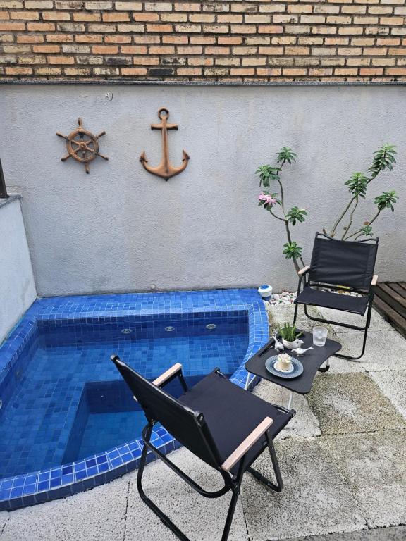 a pool with a chair and a table and a anchor at Flêbeach in Flecheiras
