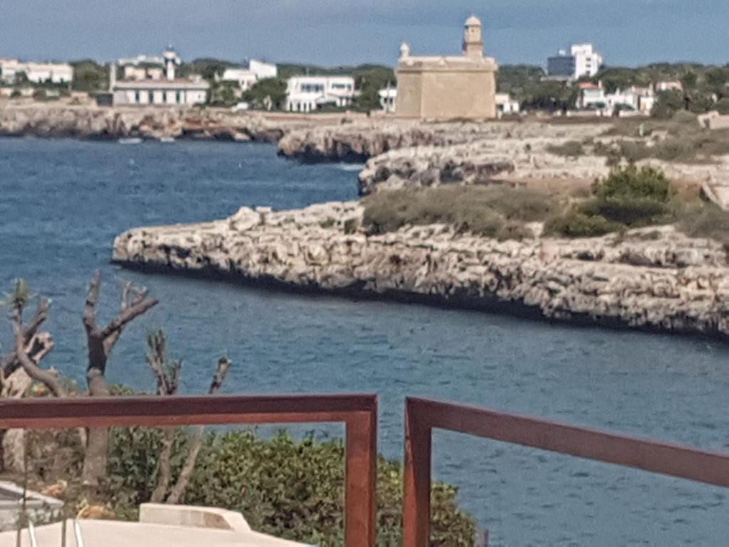 a view of a body of water from a balcony at Agua en las Rocas in Sa Caleta