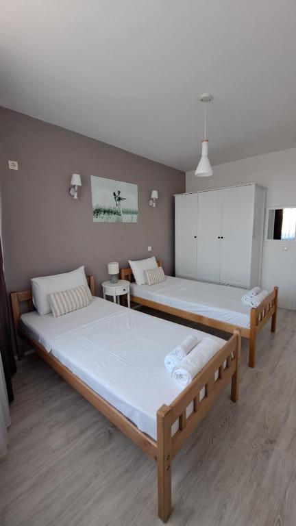a room with two beds in a room at Double Room, Shared bathroom- Rooms GEA in Prizren