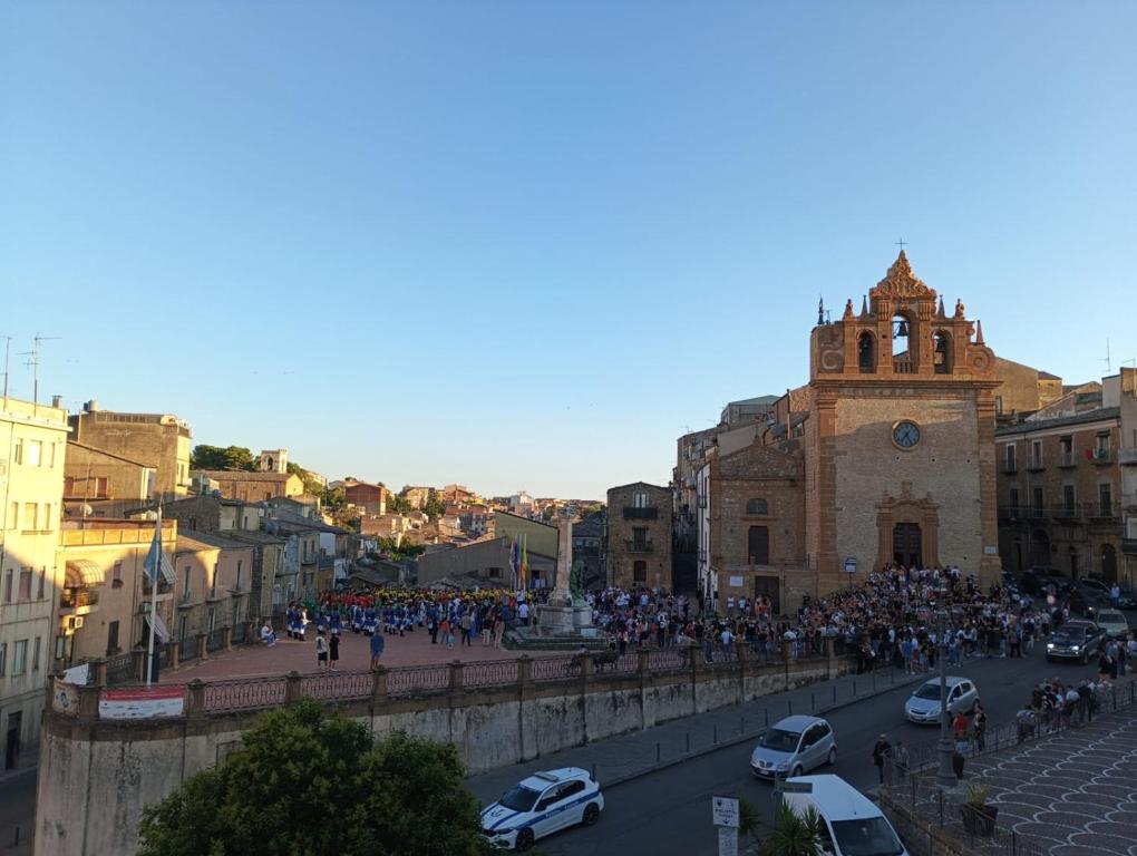 a crowd of people standing on a bridge in a city at La Casa di Joao in Piazza Armerina