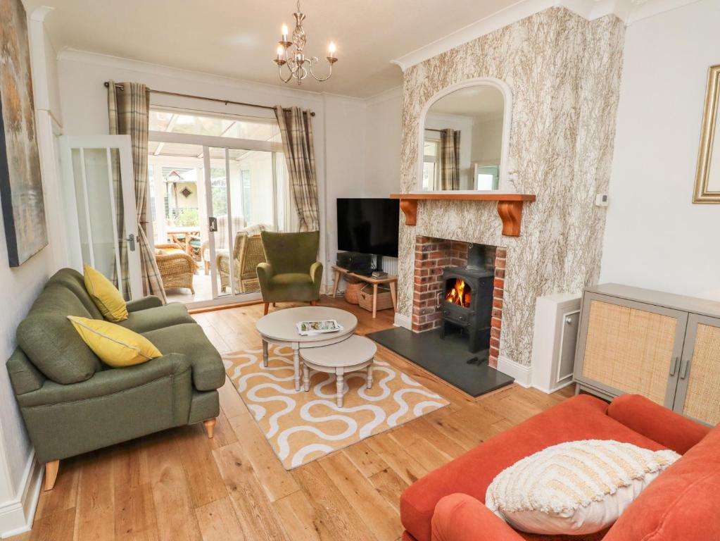 a living room with a couch and a fireplace at Rose Briar Cottage in Morpeth
