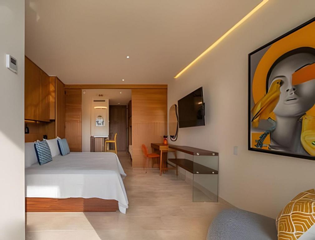 a hotel room with a bed and a desk at Estudio con Terraza en Zantamar in Cruz de Huanacaxtle