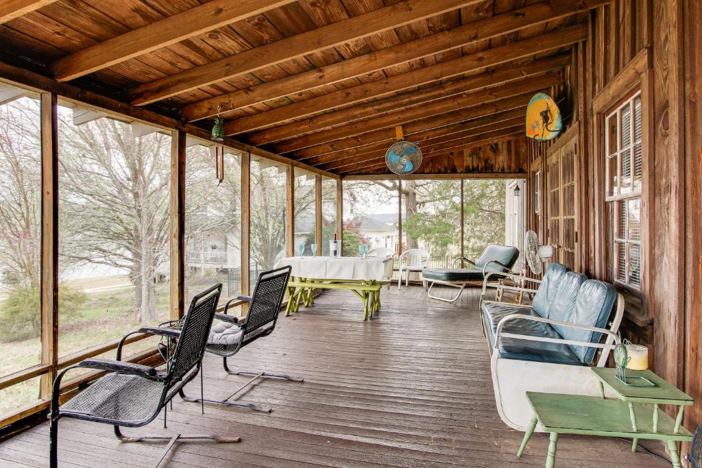 a screened in porch with chairs and a table at Private Dock and Porch Serene Lake Greenwood Escape in Greenwood