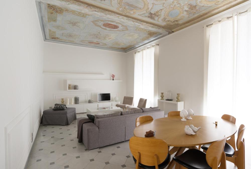 a living room with a table and a couch at Via Chiodo Luxury Apartment in La Spezia