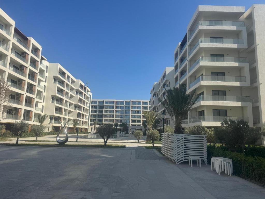 an empty parking lot in front of two tall buildings at Sea breeze Park residens 2 in Baku