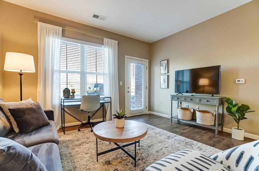 a living room with a couch and a flat screen tv at 1st Floor Monthly 2br Wd 30m To Honda Osu in Dublin