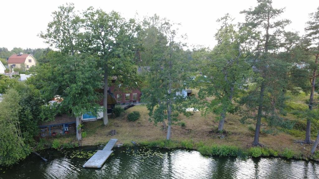 an aerial view of a house next to a lake at Scenic Lakehouse near Stockholm with Sauna & Jetty in Huddinge