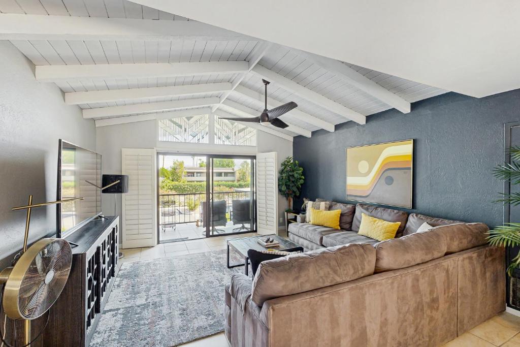 a living room with a couch and a table at Sunny Palm Springs Oasis Getaway in Palm Springs