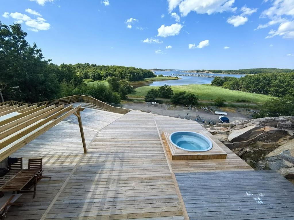 a wooden deck with a hot tub on it at Seaside Panorama Villa in Gothenburg