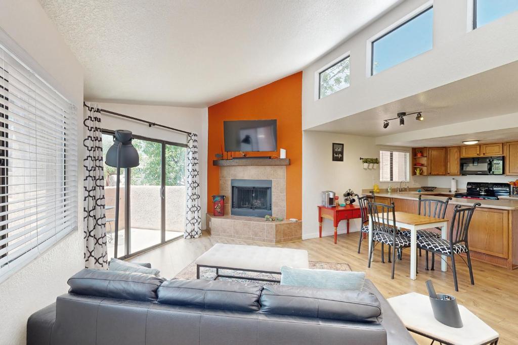 a living room with a couch and a table at Mtn-View Condo w/ Resort Amenities in Tucson! in Tucson