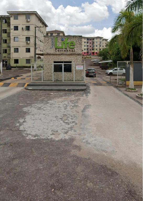 an empty parking lot in front of a building at Apartamento Life COP30 in Castanhal