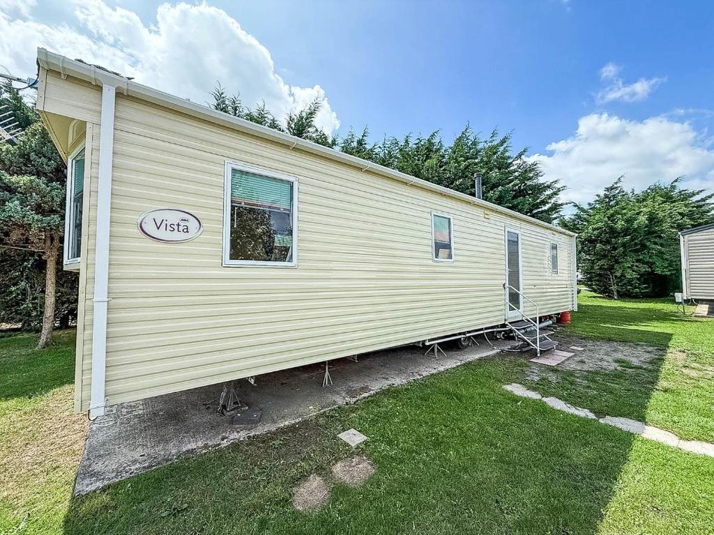 a mobile home with a visa sign on the side of it at Cosy Dog Friendly Caravan, Near To Great Yarmouth In Norfolk Ref 10029Rp in Belton