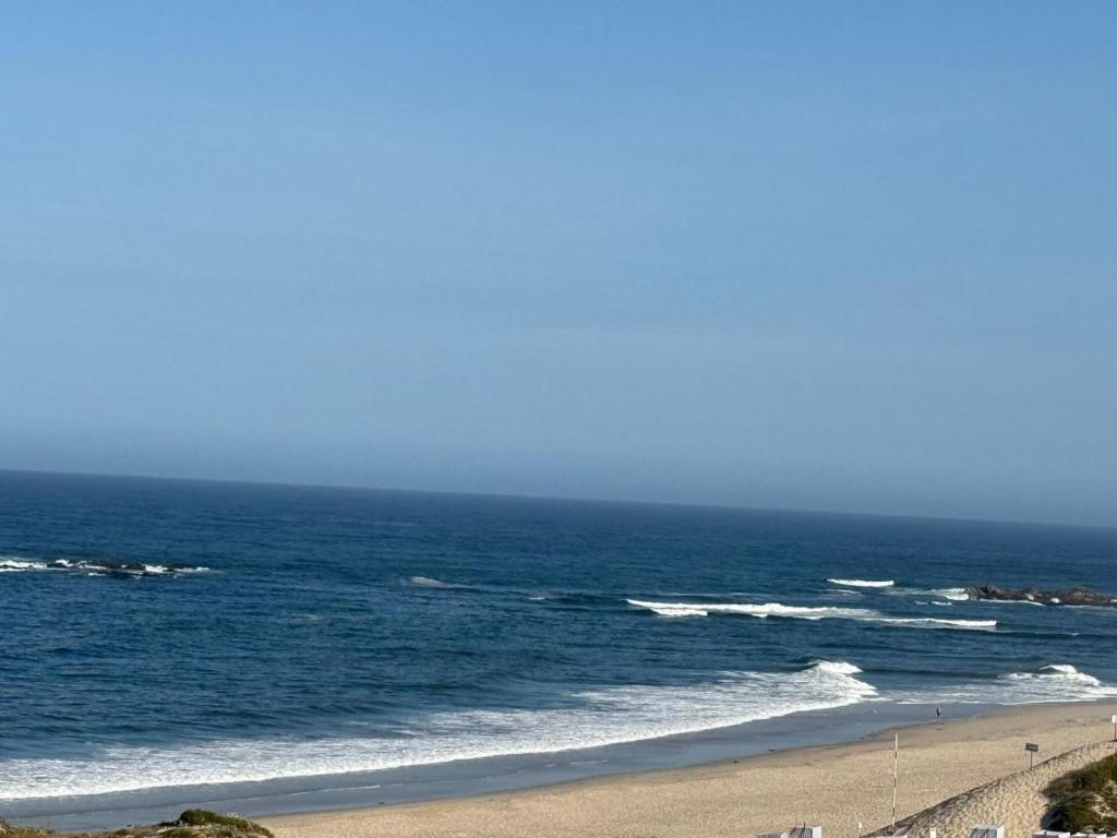 a view of the ocean from a beach at Apartamento LUZ DA PRAIA in Vila Chã