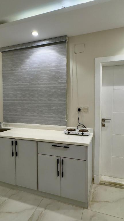 a bathroom with a window and a white sink at Studio with a calm and comfortable designse in Al ‘Awālī