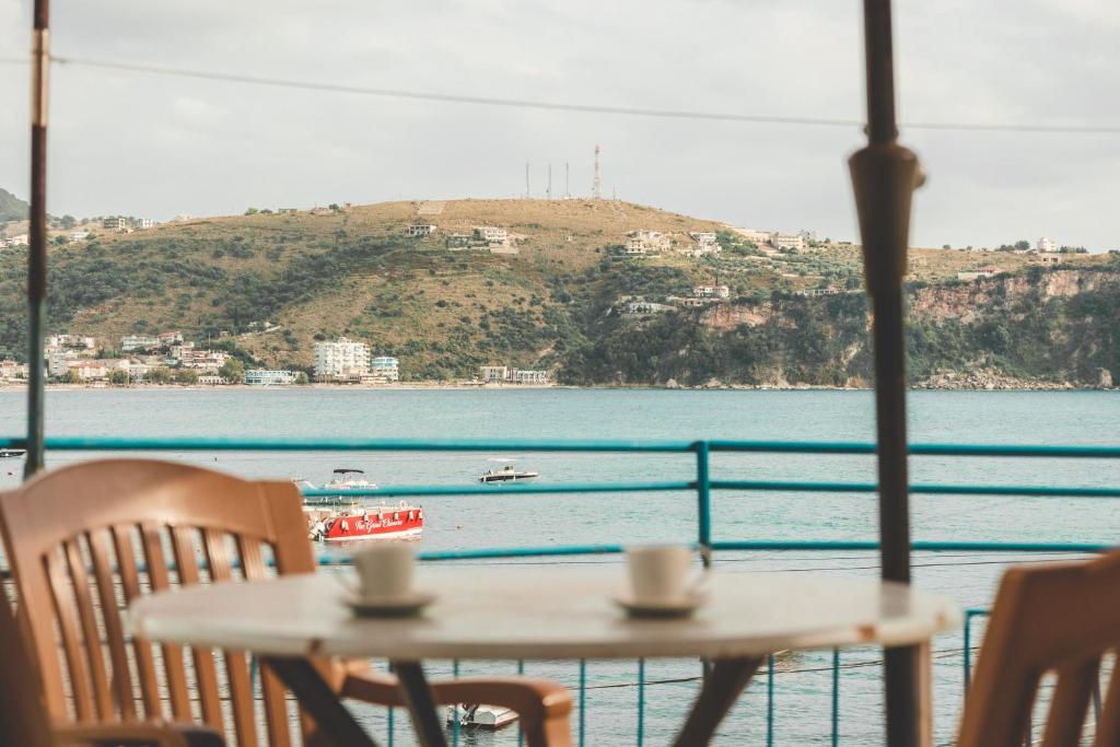 a table and chairs with a view of the water at City & Sea Hideout in Himare