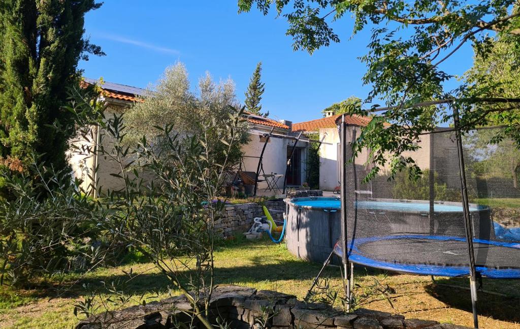 une maison avec une piscine dans une cour dans l'établissement Nature et baignades au nord de l’Hérault, à Saint-Bauzille-de-Putois