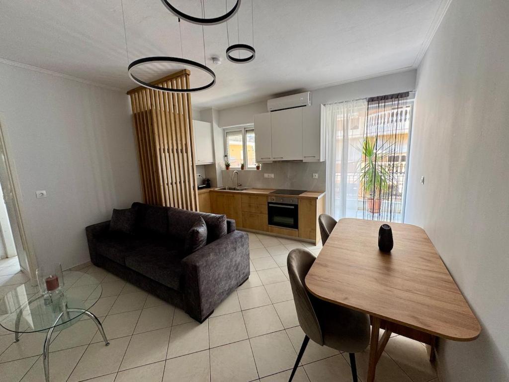 a living room with a couch and a table at Salt & Soul downtown apartment in Mesolongion