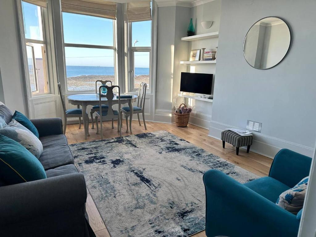 a living room with a couch and a table at Newly Refurbished - Margate Sunset Retreat in Margate