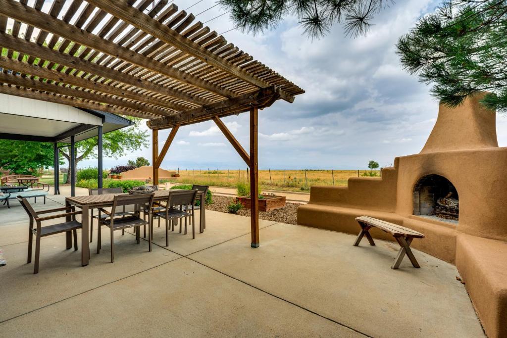 a patio with a table and chairs and a fireplace at Mtn-View Home with Pickleball Court in Louisville! in Louisville