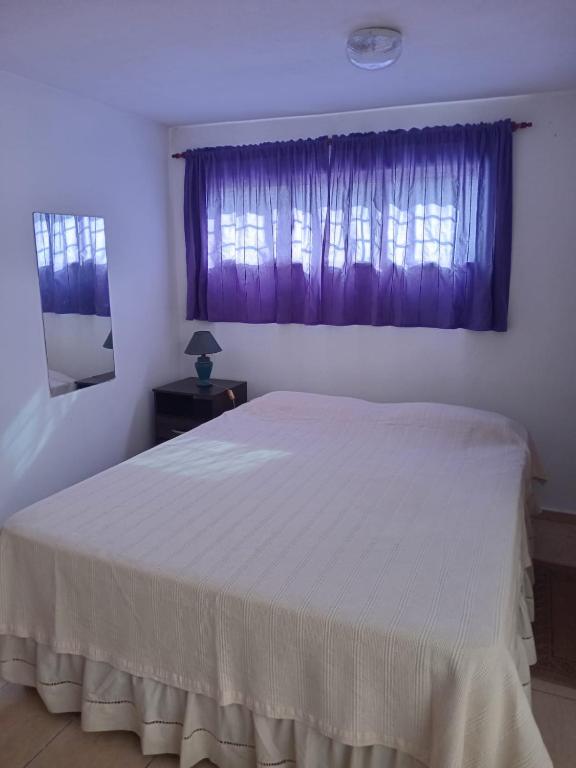 a bedroom with a white bed and a window at Mafalda in Tanti