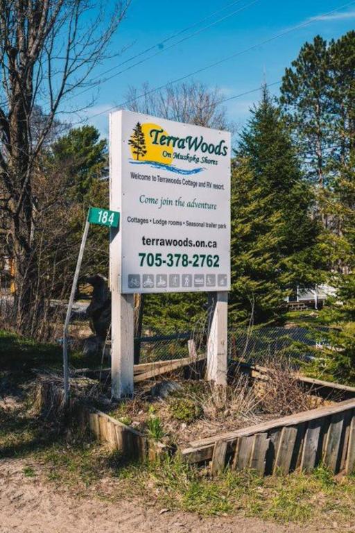 a sign for a wood company on the side of a road at The Pines Cottage on the Lake in Otter Lake