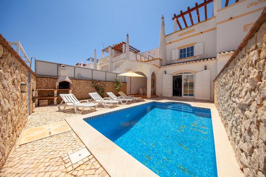 a swimming pool in front of a villa at Sea Breeze Guesthouse in Lagos