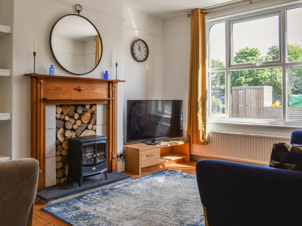 a living room with a fireplace and a television at 2 Le Dorney Villa - Uk49804 in Par