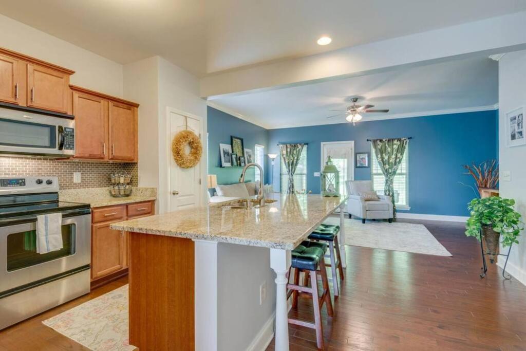 a kitchen with blue walls and a counter top at Cheerful Nashville Home In Hip Westmeade! in Nashville