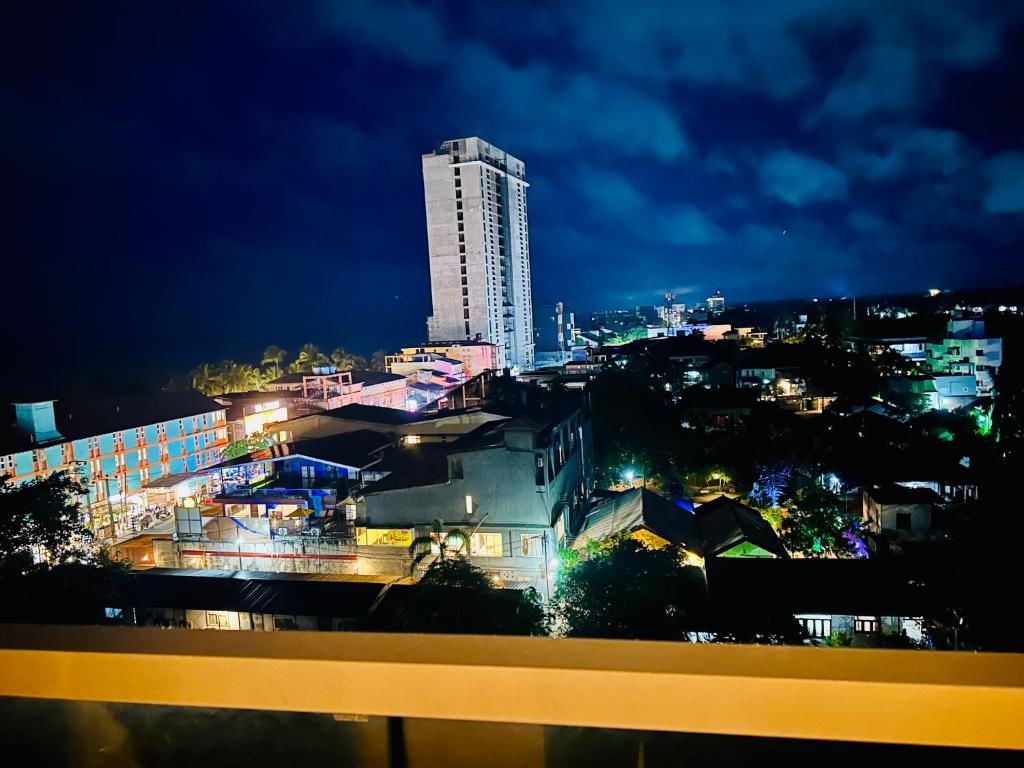 a city skyline at night with a tall building at Sea view Serenity Negombo in Negombo