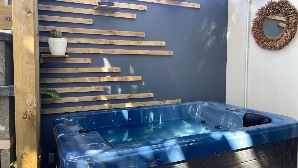 a blue tub in a room with a staircase at Villa MYA Location in Saint-Pierre