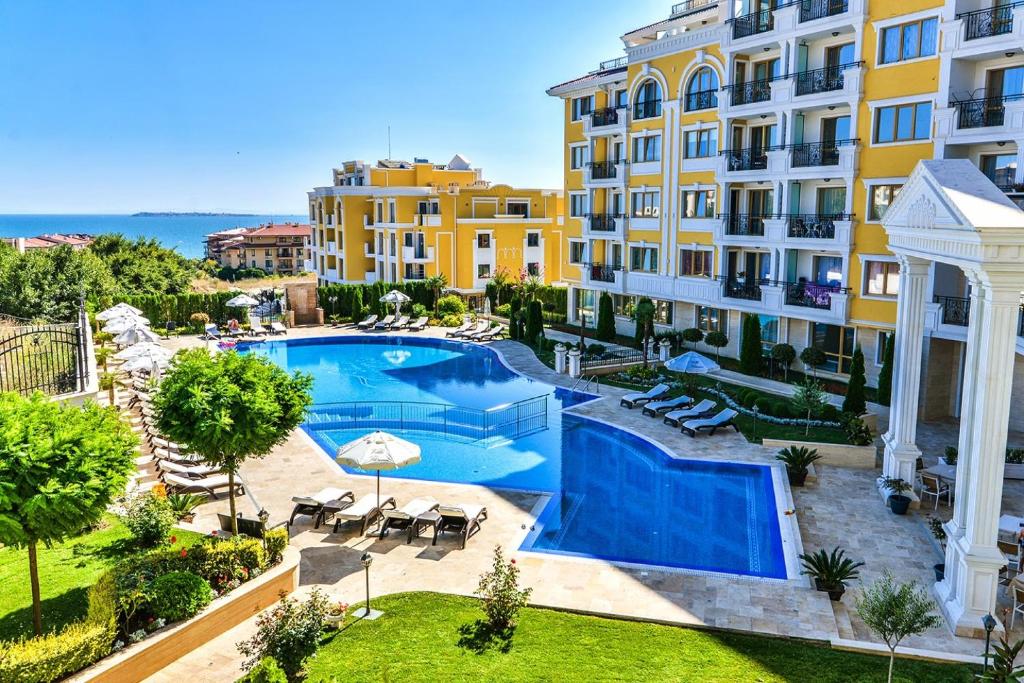 an apartment with a swimming pool next to a building at Romantic Studio Florence in Sveti Vlas