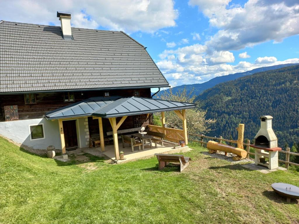 a large building with a roof on top of a hill at Berghütte Reissnerhof in Ranten