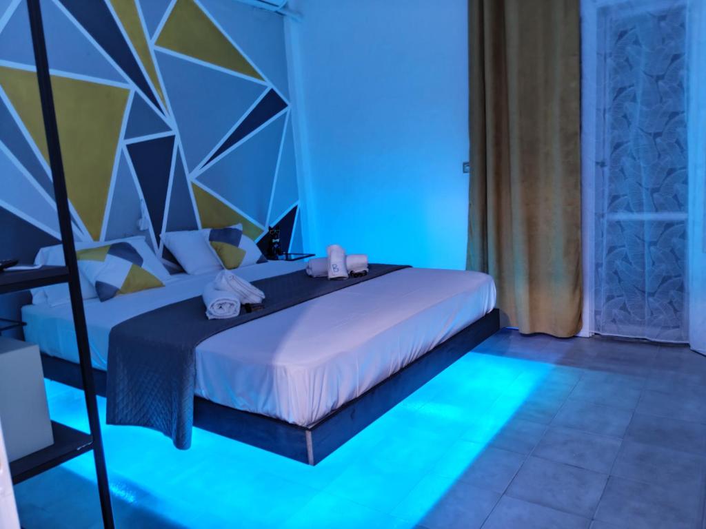 a bedroom with a bed with blue lights on it at Boulitos 1 in Kavos