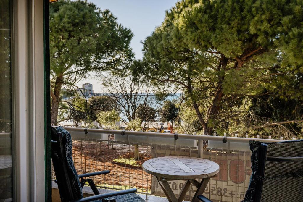 a balcony with a table and chairs and a view of the water at 4SONS UMAG Sea View 2BR Apartment in Town center !NEW! in Umag