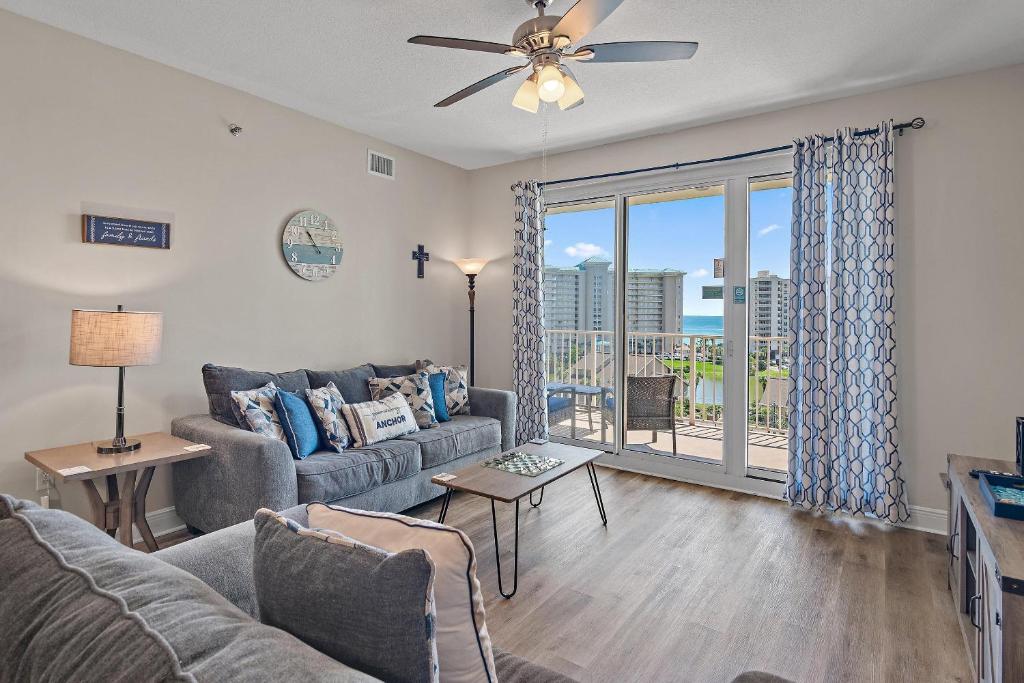 a living room with a couch and a ceiling fan at Ariel Dunes II 703 in Destin