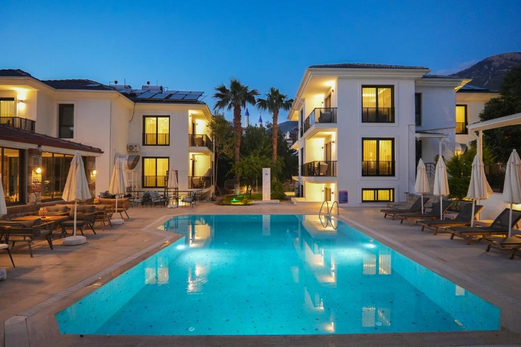 a large swimming pool in front of a building at Marla Suite Fethiye in Fethiye