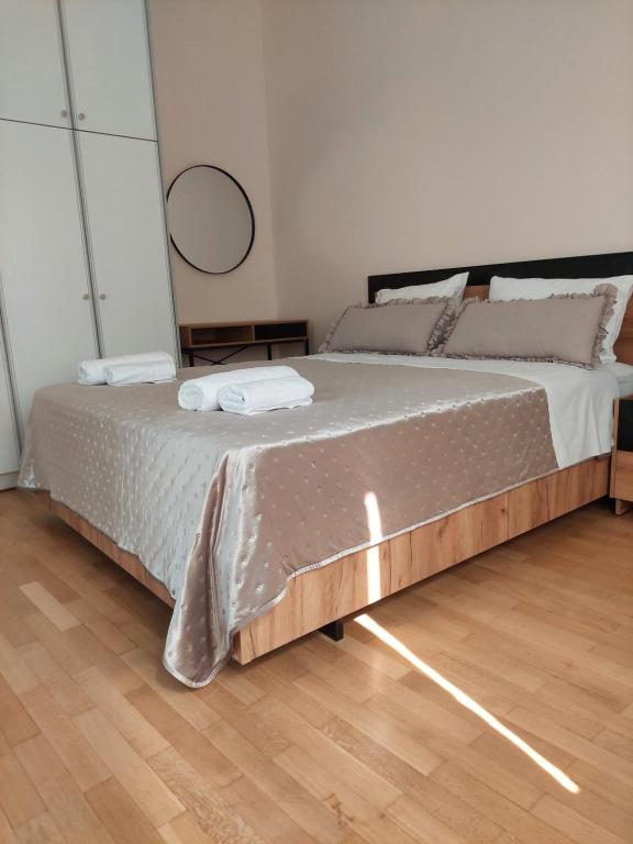 a bedroom with a bed with two towels on it at Natasa's Appartment in Kalamata in Kalamata