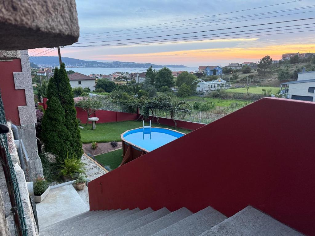 a view from the balcony of a house with a swimming pool at Casa las Hiedras in Marín