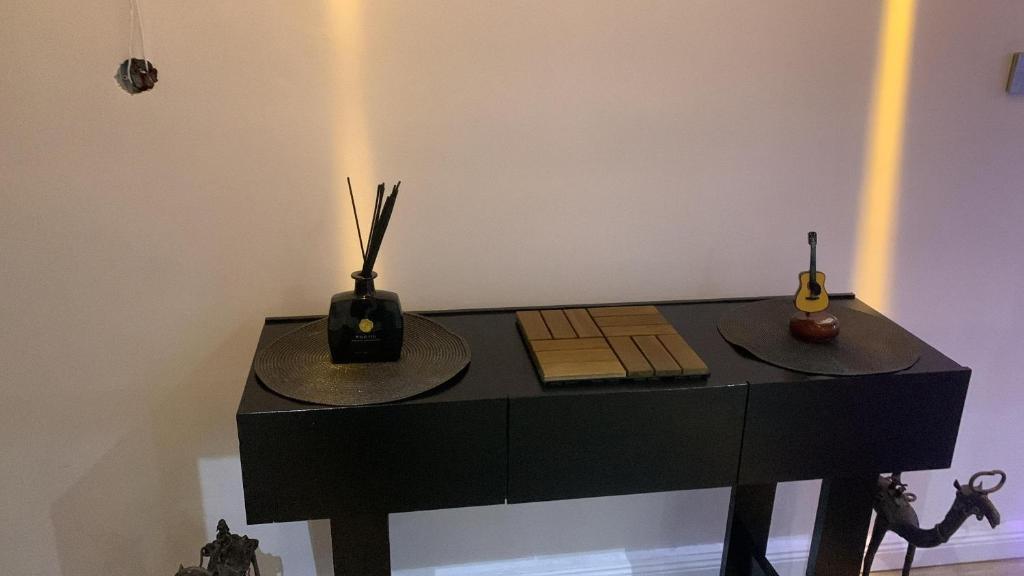 a black table with two hats on top of it at Daffodil House 3 Bed Terrace in Lekki Phase 1 with 24hr Light & Security in Mama