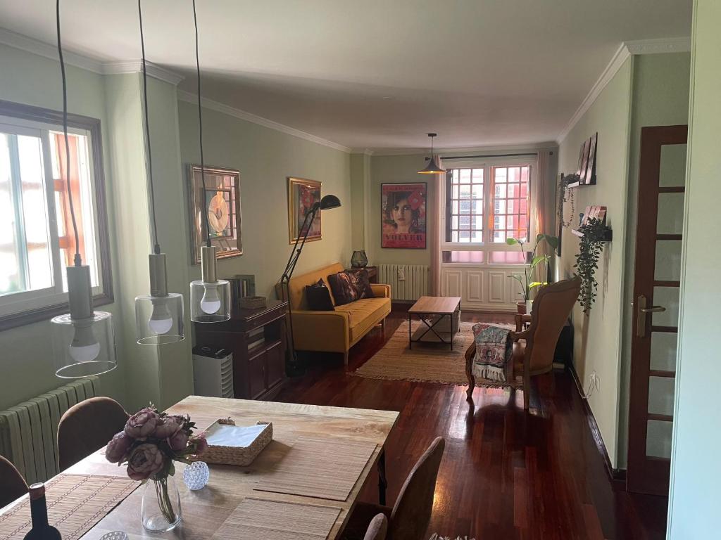 a living room with a table and a couch at Figueroa Apartments in Pontevedra