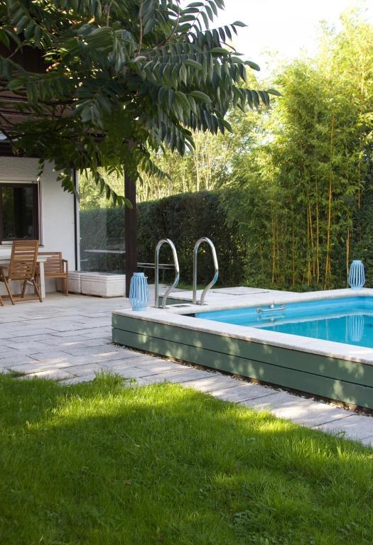 a swimming pool in the backyard of a house at Ferienhaus Fringaluna in Übersee