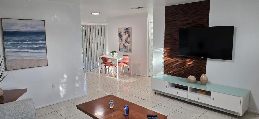 a living room with a flat screen tv on a wall at Costerra Living in Naples