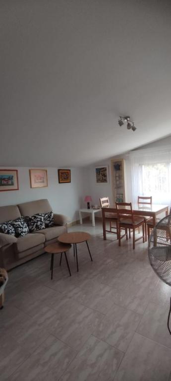 a living room with a couch and tables in it at Alojamientos Manuela 1 in Vilagarcia de Arousa