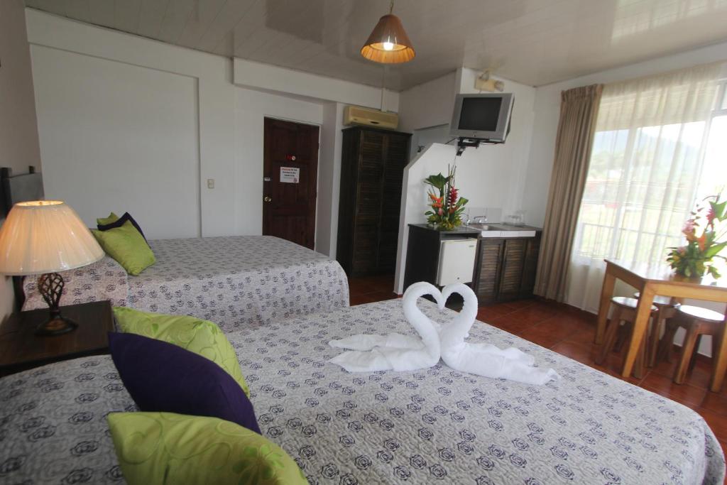 Postel nebo postele na pokoji v ubytování Hotel Arenal by Regina