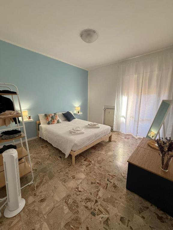 a bedroom with a bed and a shelf in it at Trilocale sul mare - SOLEeSALE in Pescara
